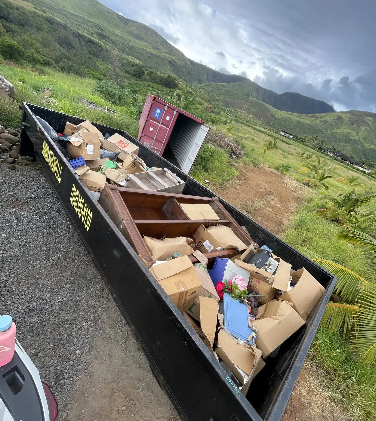 A Hawaii Hauling bin loaded with household junk